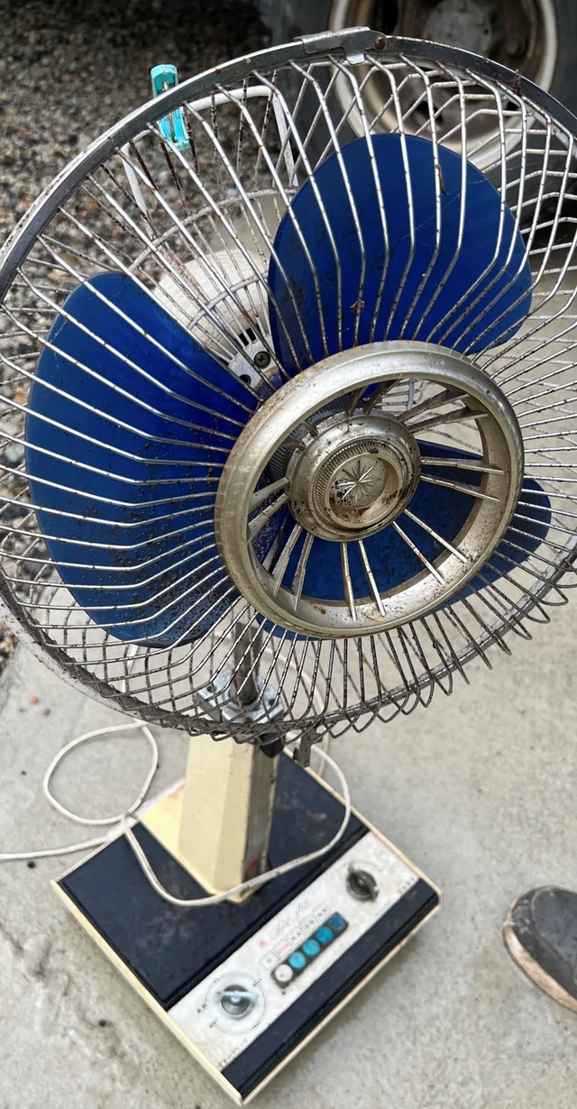 青い羽根と金属製のガードがある扇風機